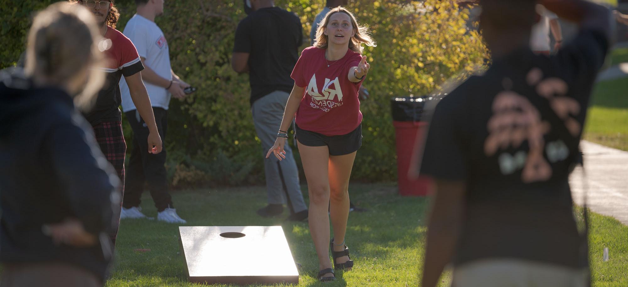 Students playing a bean bag toss